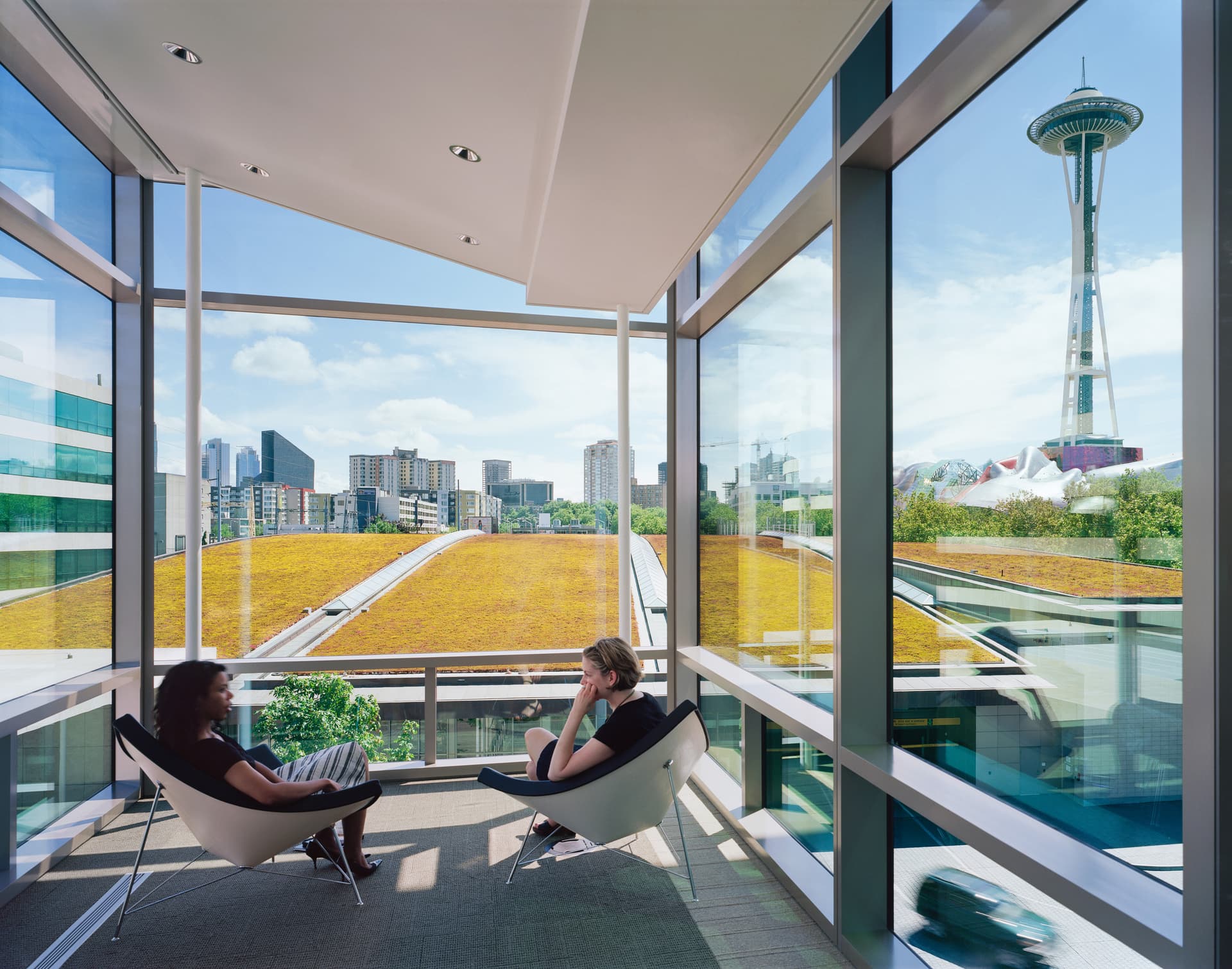 Informal meeting spaces at the end of each breezeway overlook downtown Seattle.,,,, Photographer: Timothy Hursley